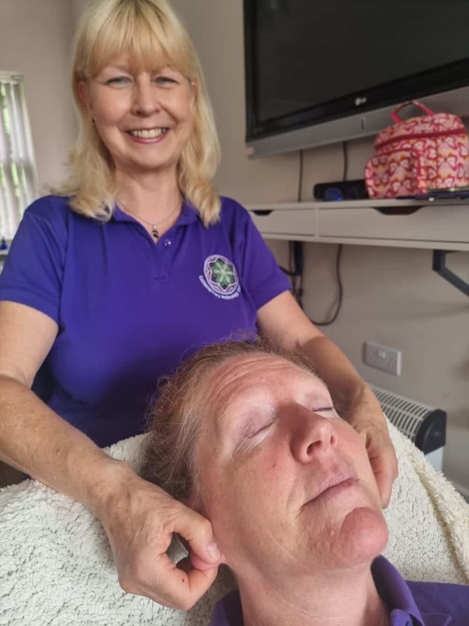 Allison Walker treating student learner Jane Ford to Auricular Reflexology